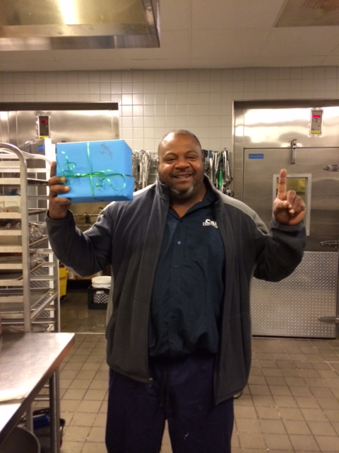 Cal Dining worker holds up giftbox
