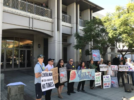 Tunnels opponents gather outside the Metropolitan Water District of Southern CA, protesting with signs.